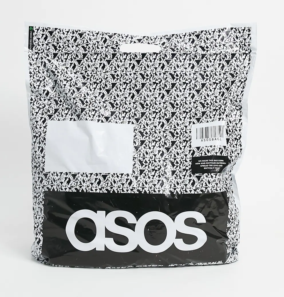 ASOS black-and-white patterned mailing bag with a label reading 'we made this bag using new and recycled materials'
